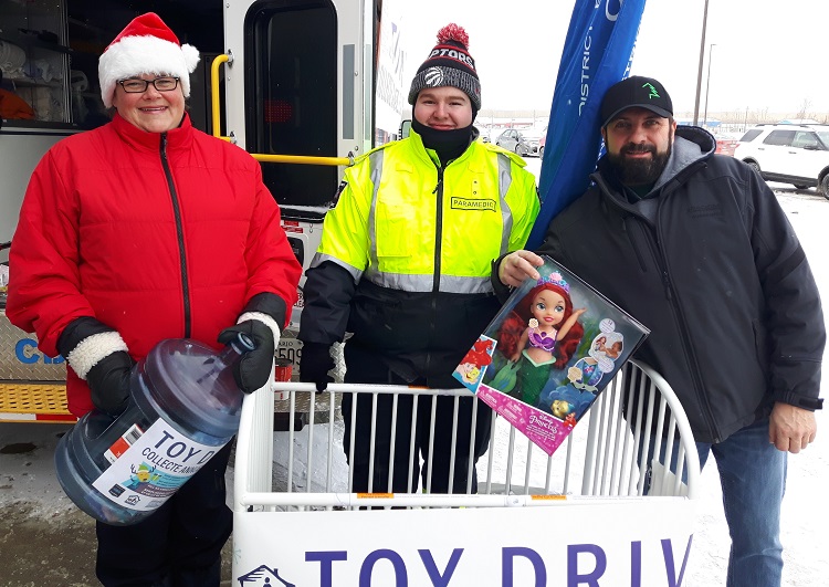 MEDICS, VOLUNTEERS STUFF A CRIB WITH TOYS