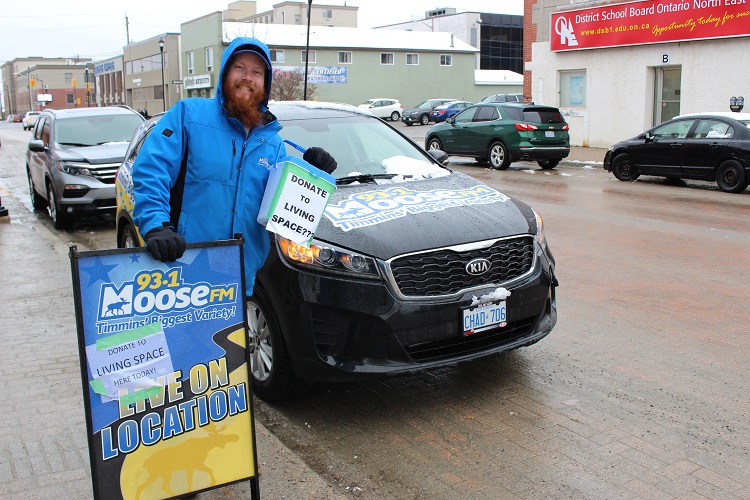 Neither rain nor snow nor slush will keep Tom from his Living Space fundraiser