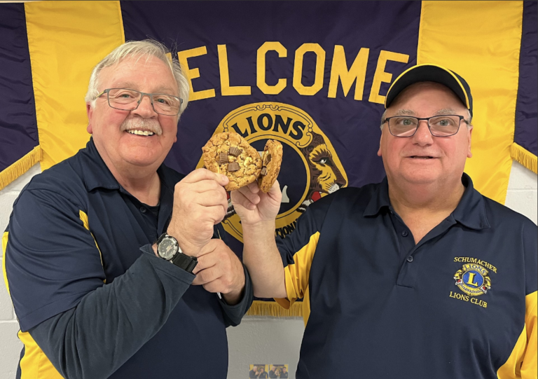 The Schumacher Lions are pleased to be part of the upcoming Tim Hortons Holiday Smile Cookie Campaign. Toasting the occasion with Tim Hortons cookies are Lions Club President Danny Ansara, left, and Stan Fowler Fund Chairman John McCauley. (Photo submitted and used with permission)